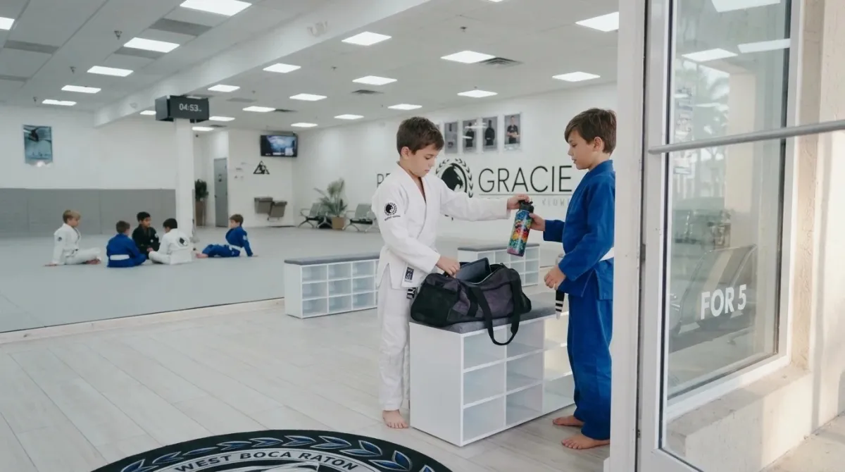 A child putting a tablet into a gym bag before leaving for class