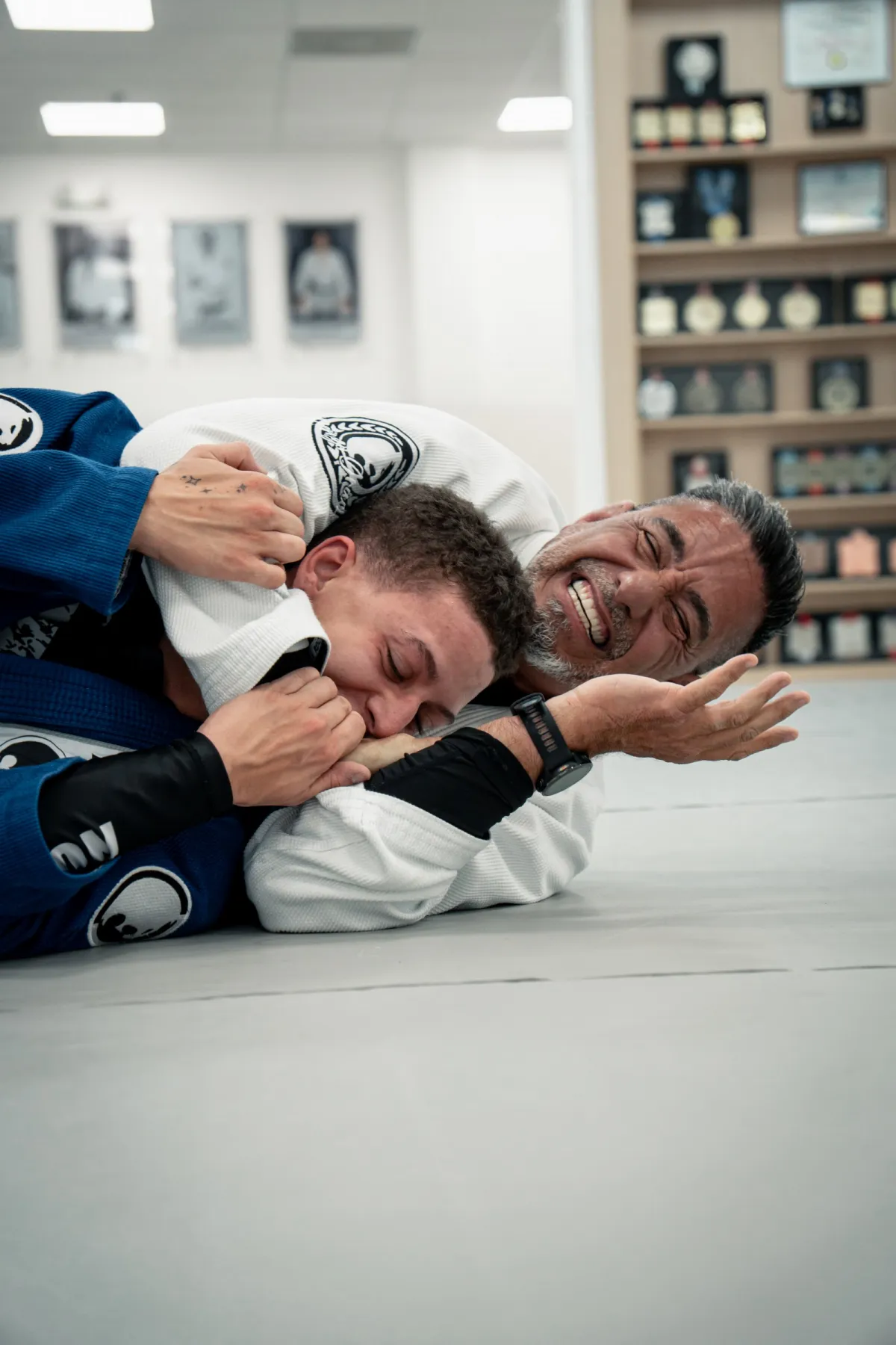Instructor teaching and laughing with students on the mat at Renzo Gracie West Boca Raton
